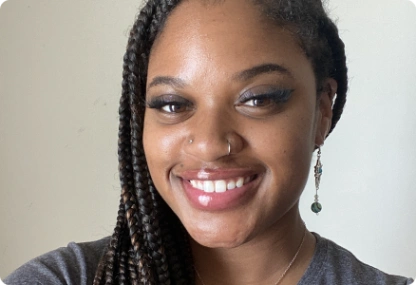Smiling woman with braided hair, close-up portrait