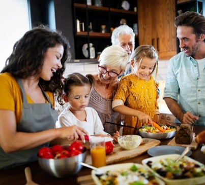 Multigenerational family gathered around a table enjoying a healthy meal