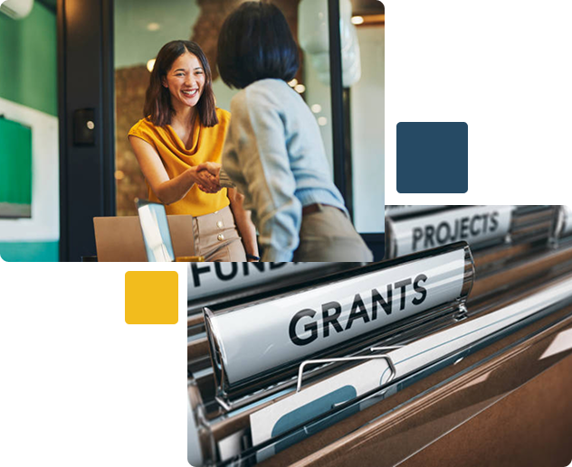 Two women having a discussion in front of a grant and funding documents folder