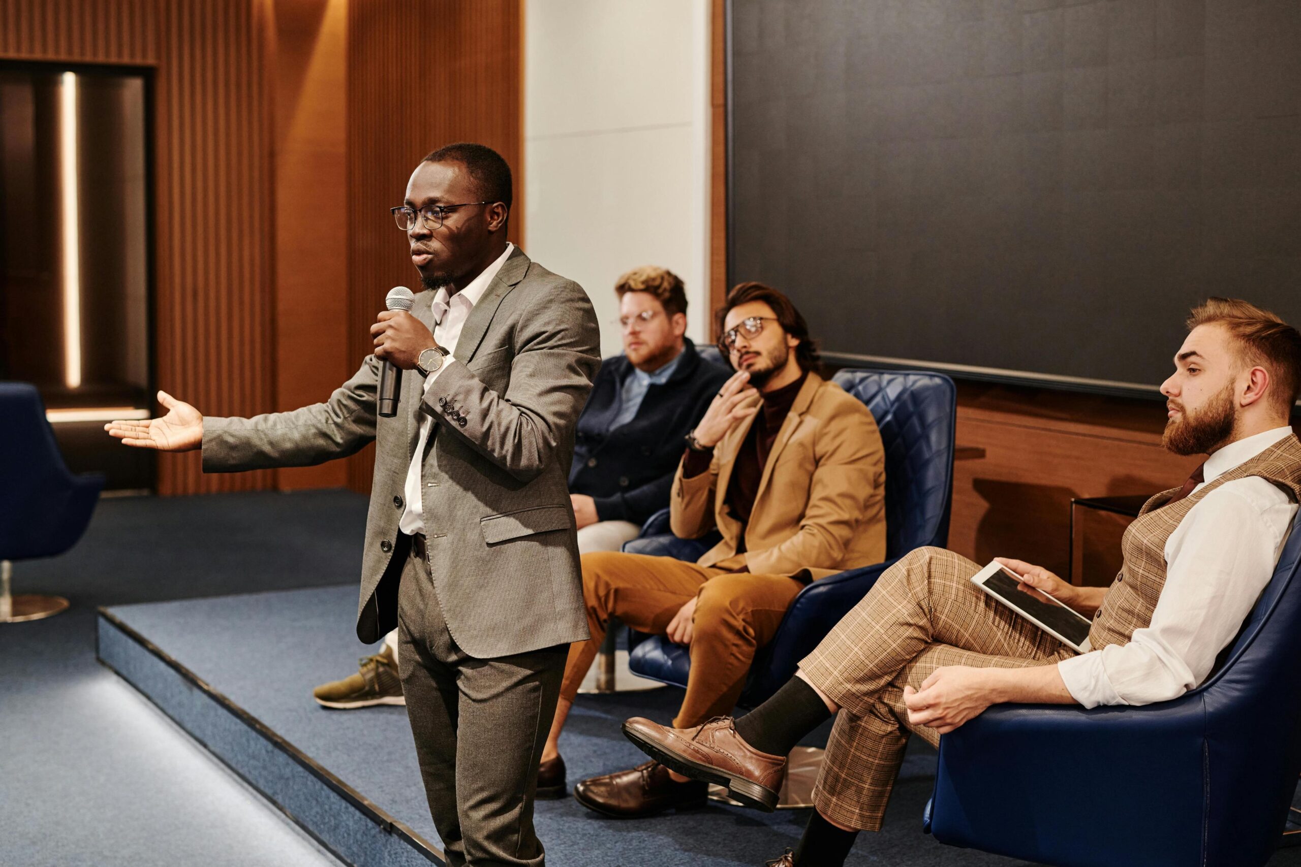 Speaker presenting to an audience in a panel discussion